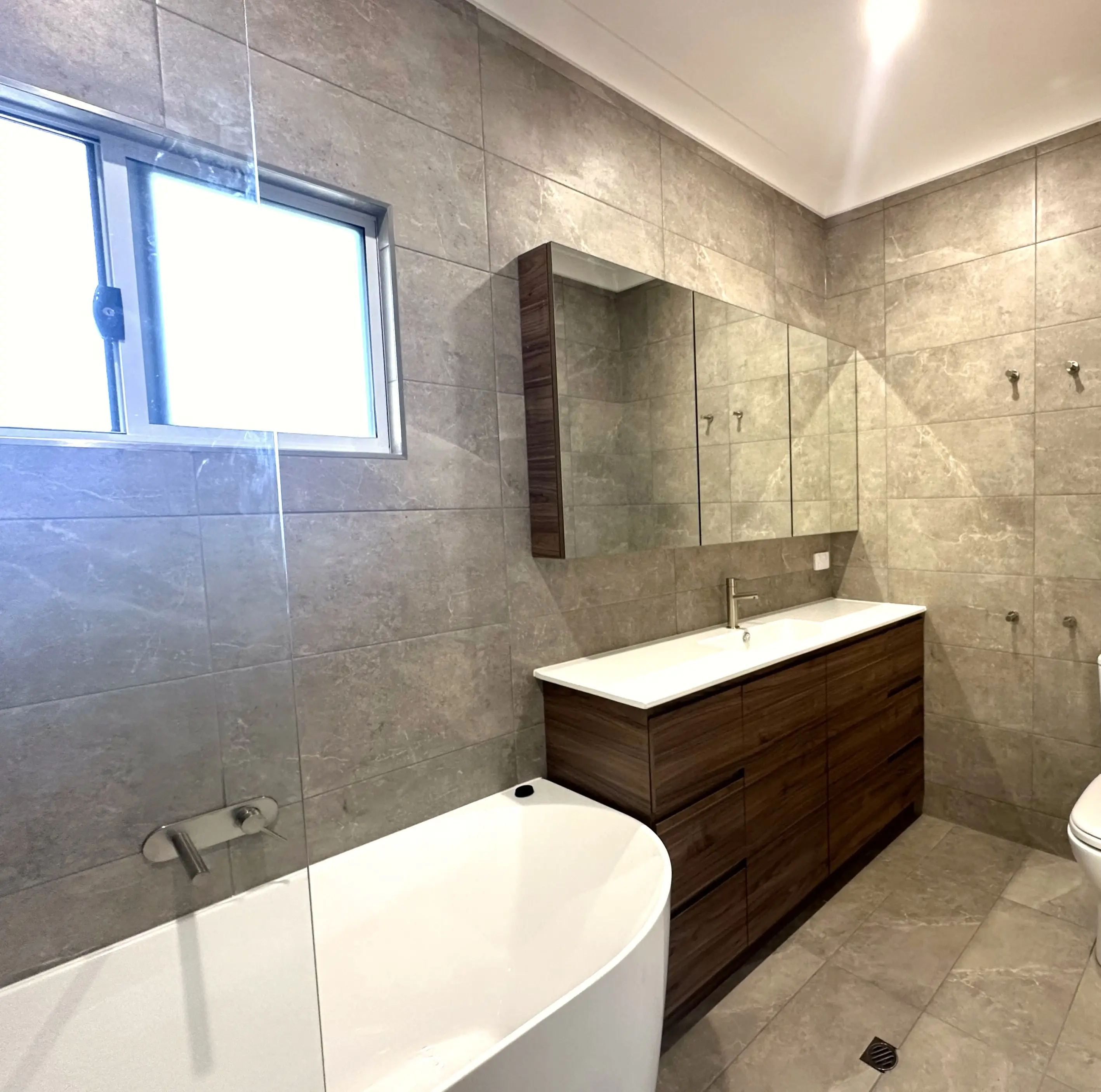 Main bathroom with a freestanding bath, built into a new lower level