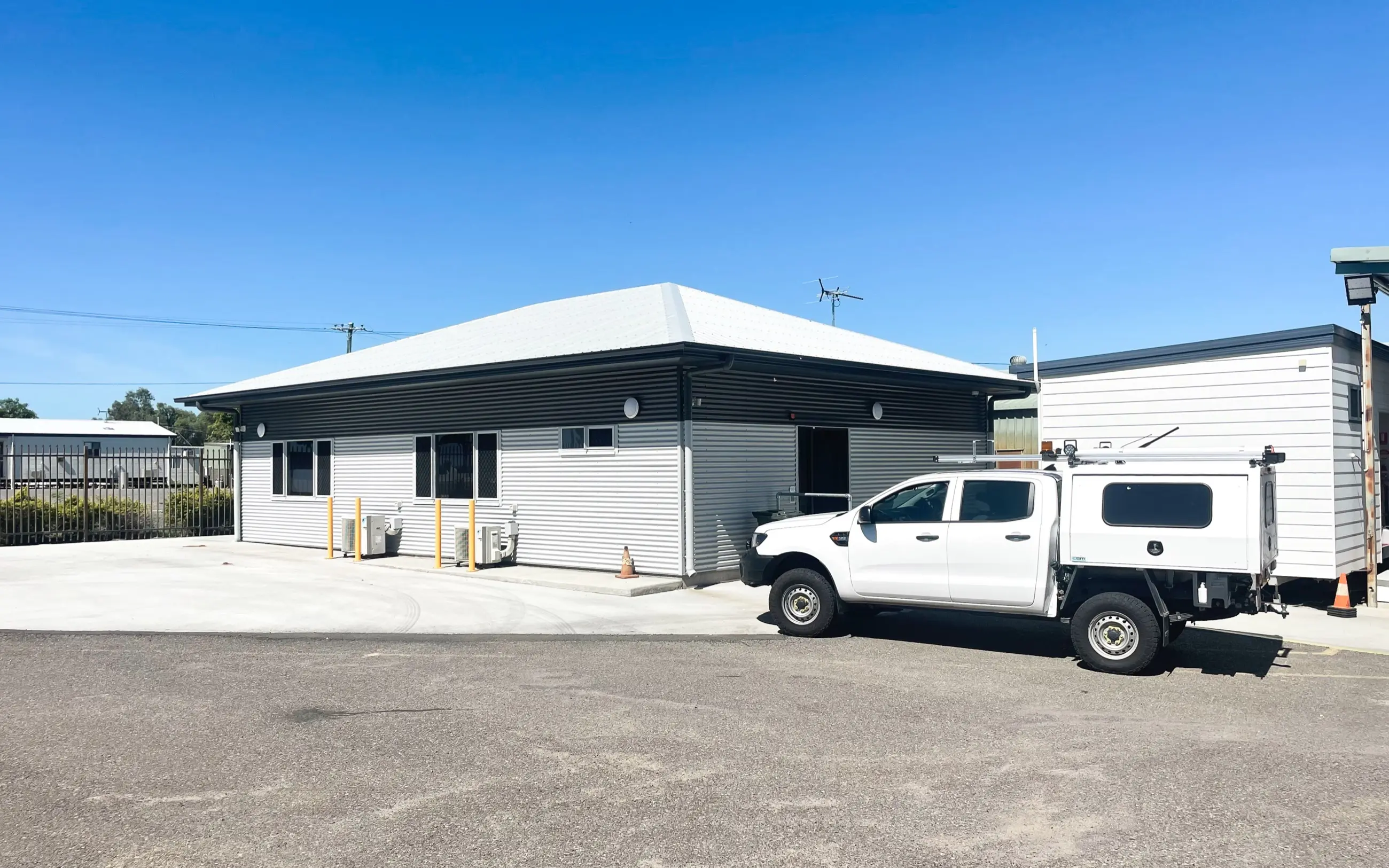 Completed regional office building with corrugated cladding and a broad covered entry