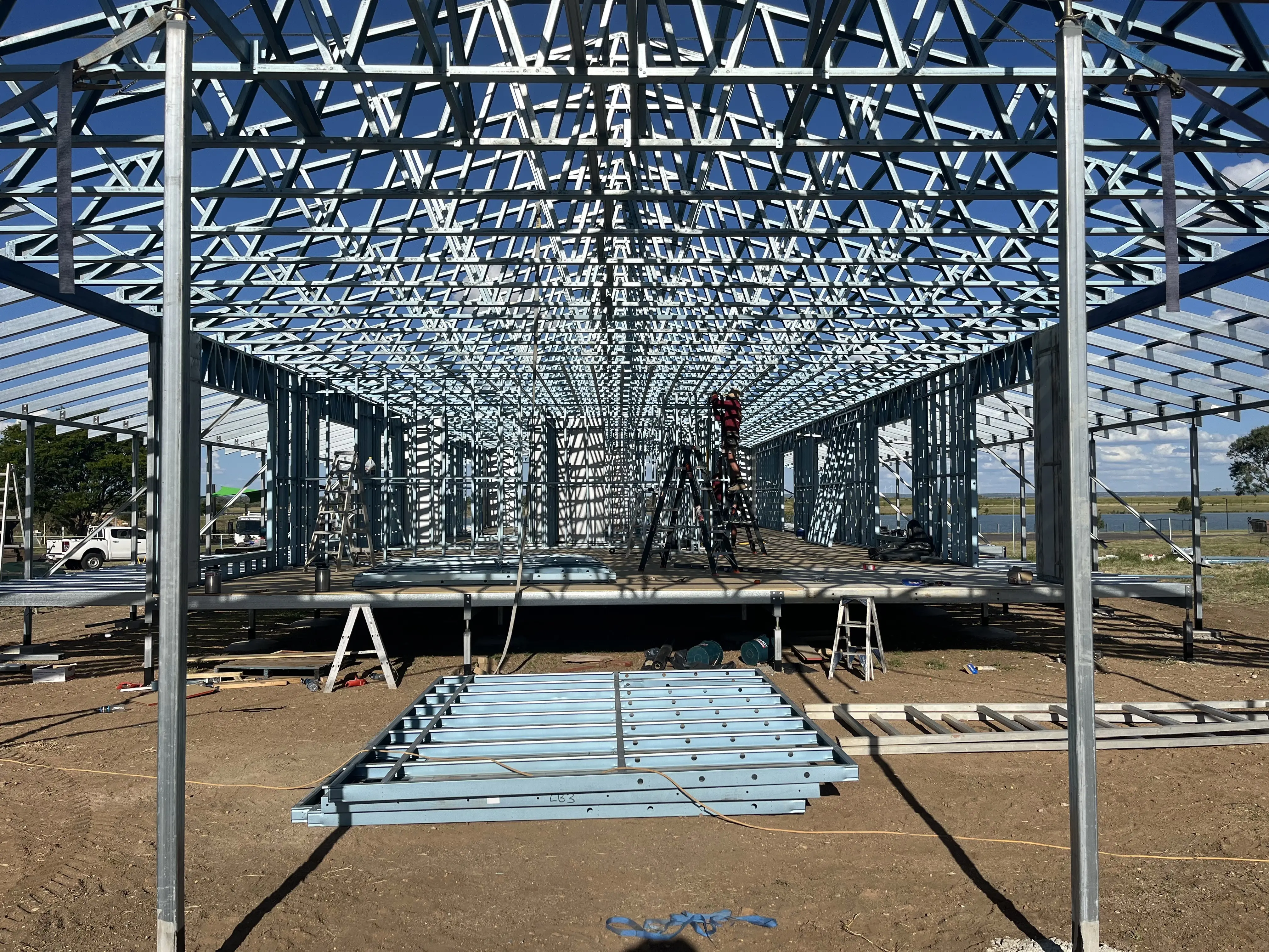 Roof trusses set over a new steel frame, seen from below