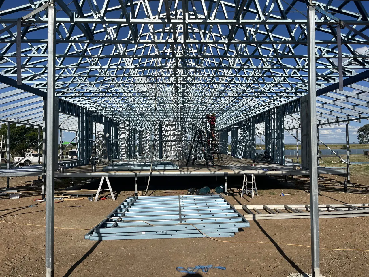 Roof trusses set over a new steel frame, seen from below