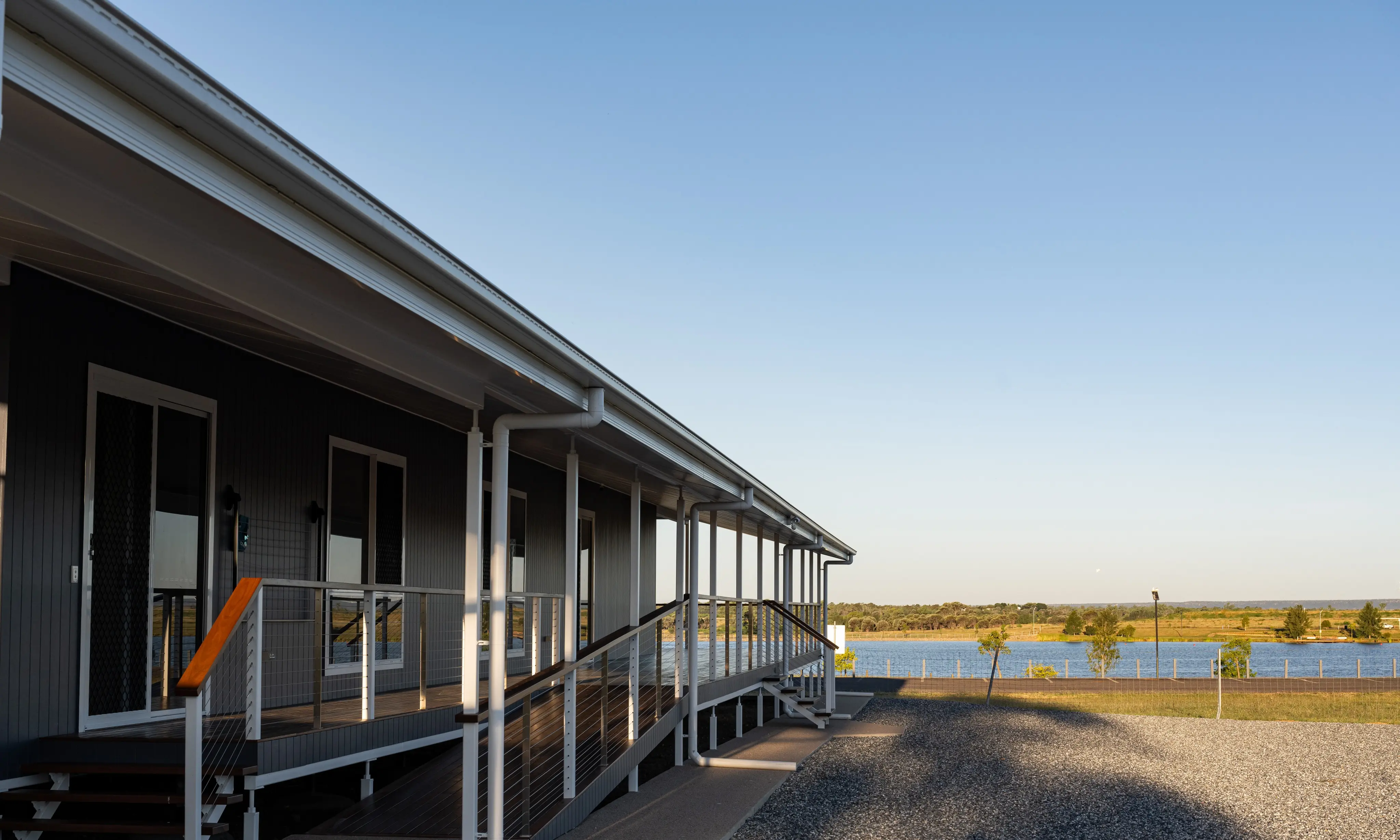 A verandah running down toward the lake at golden hour