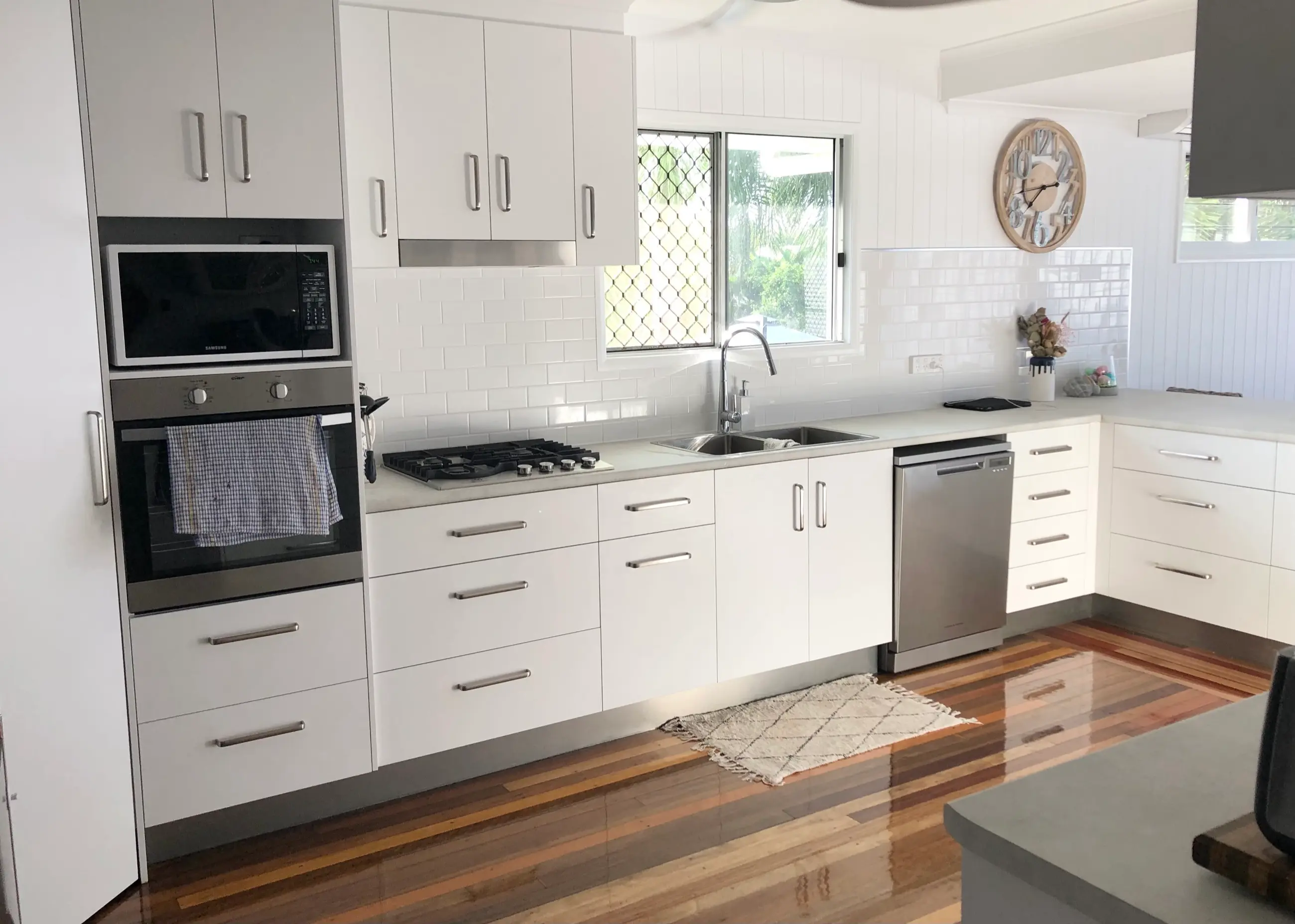 Completed Lancaster Street kitchen with white cabinetry and polished timber floors