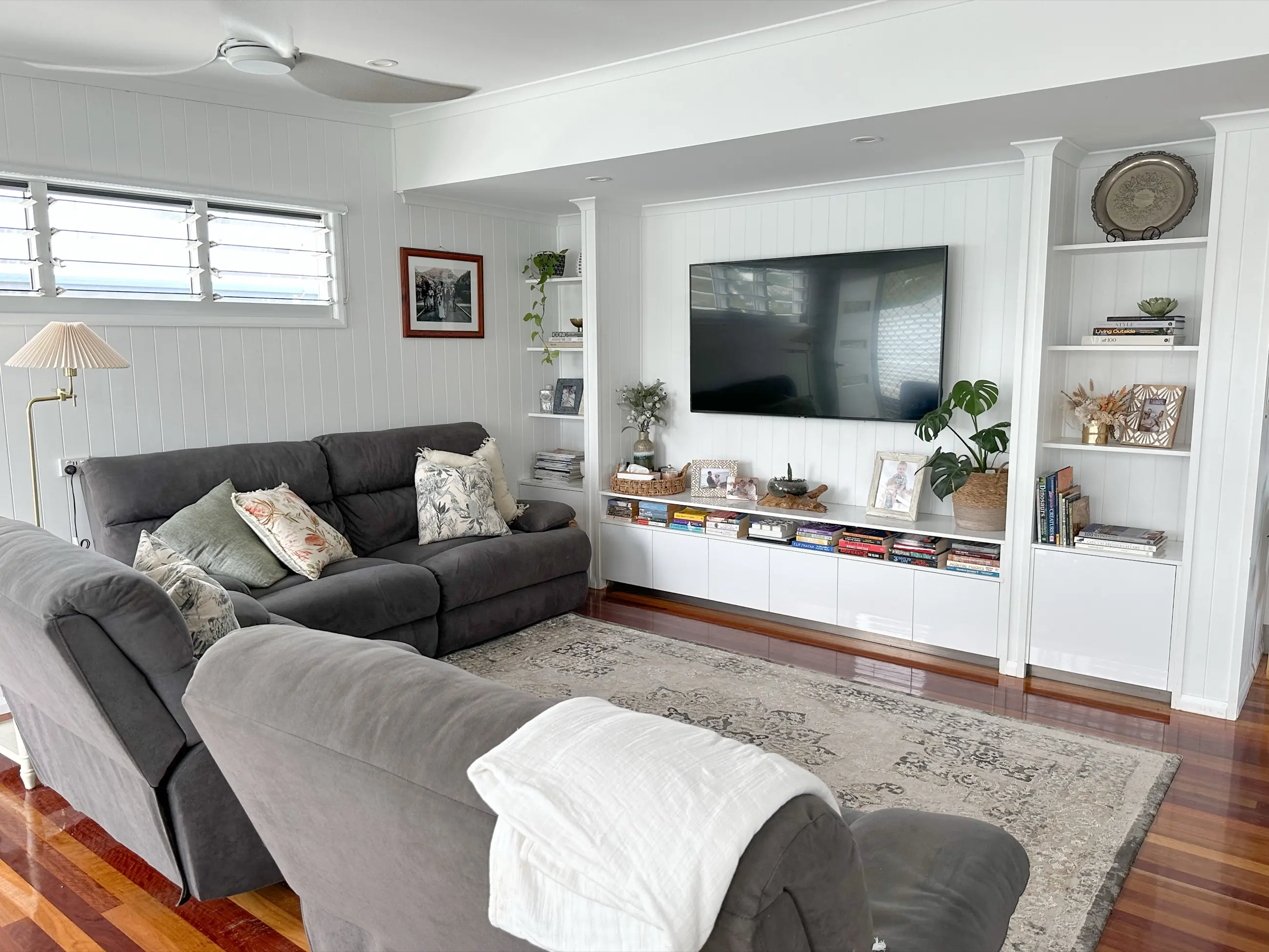 Completed Lancaster Street living room with wall-to-wall joinery and white vertical lining