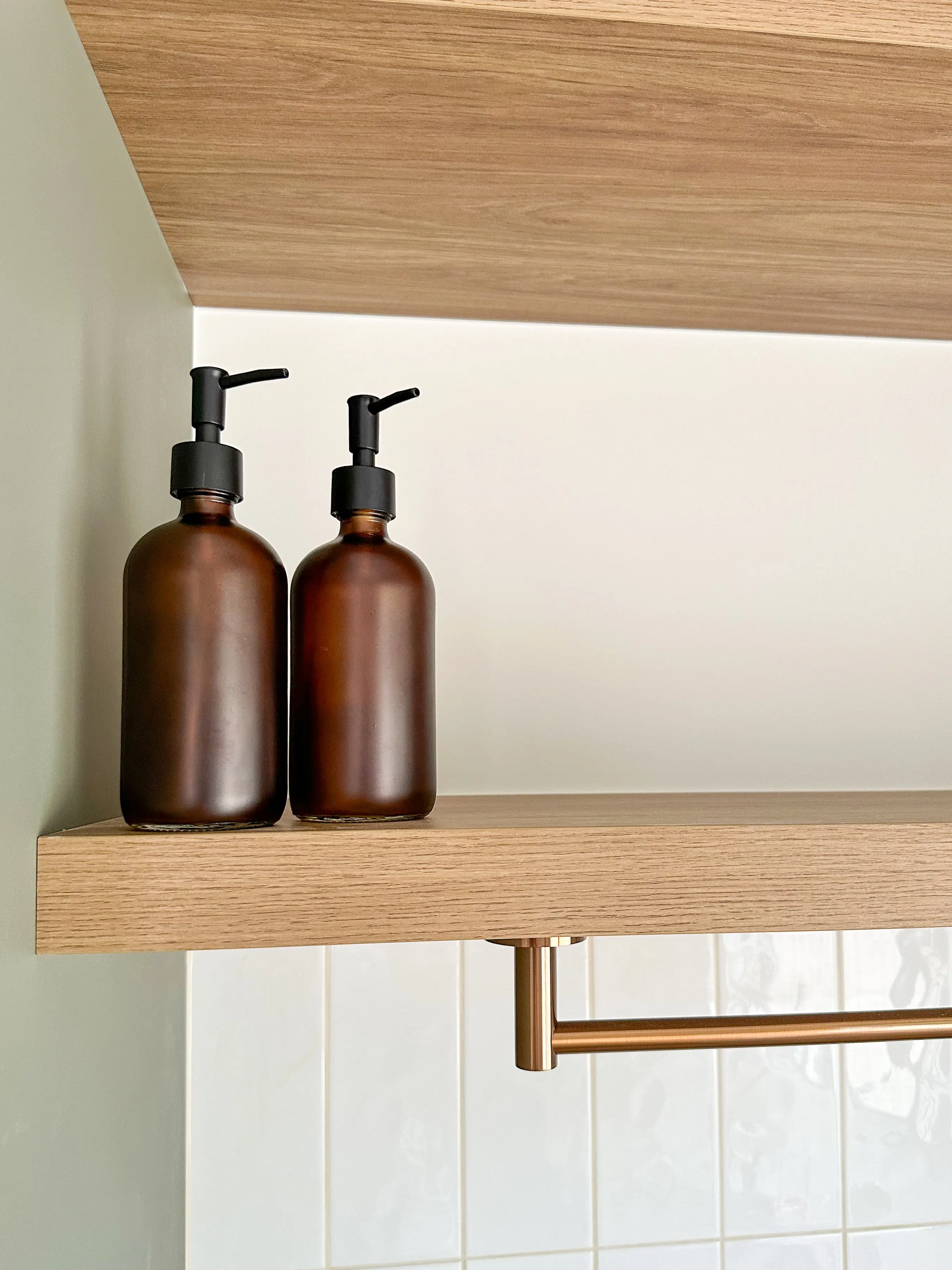 Detail of a floating shelf against tiled wall