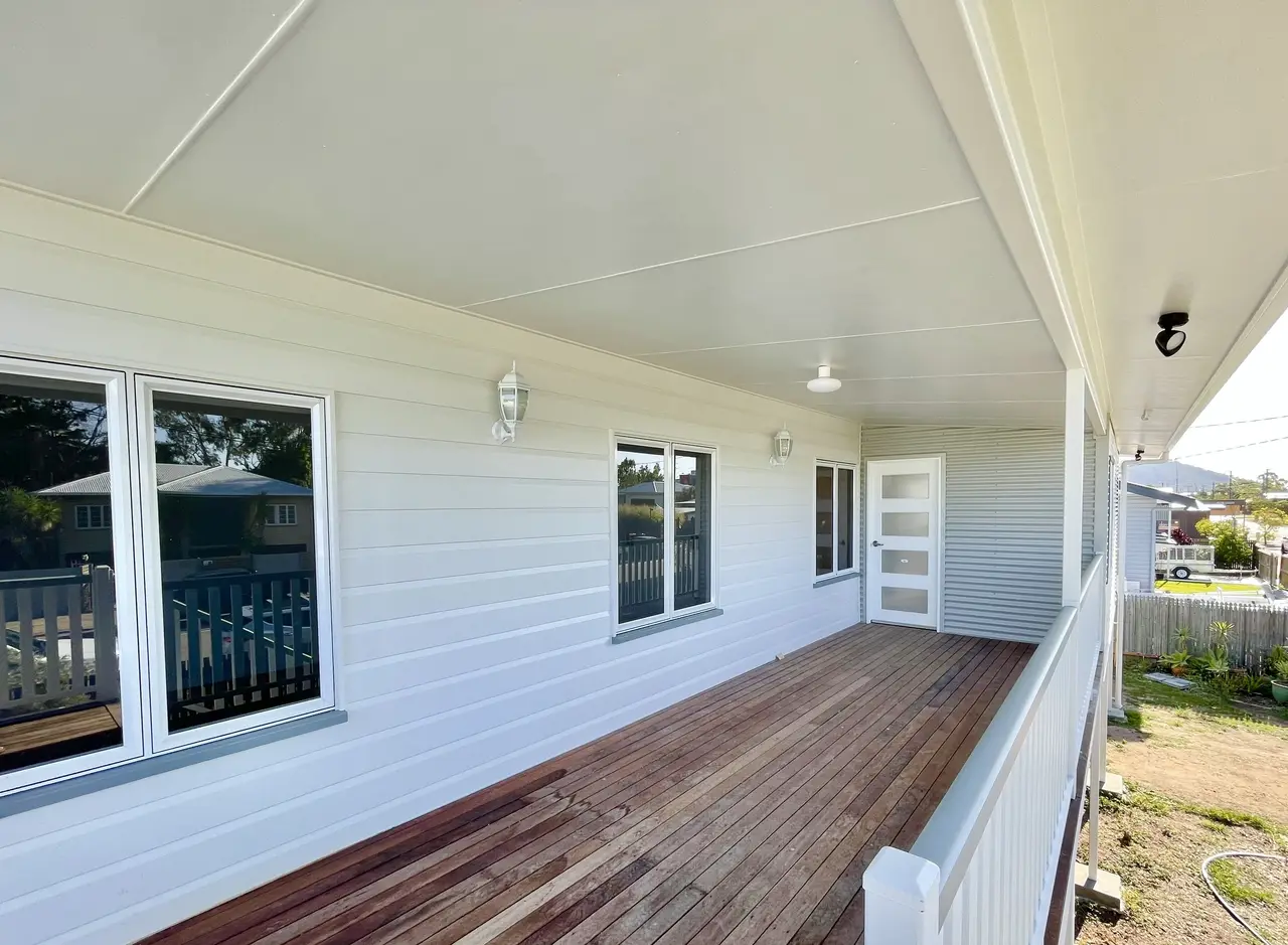 A new front verandah with hardwood decking against white lining boards