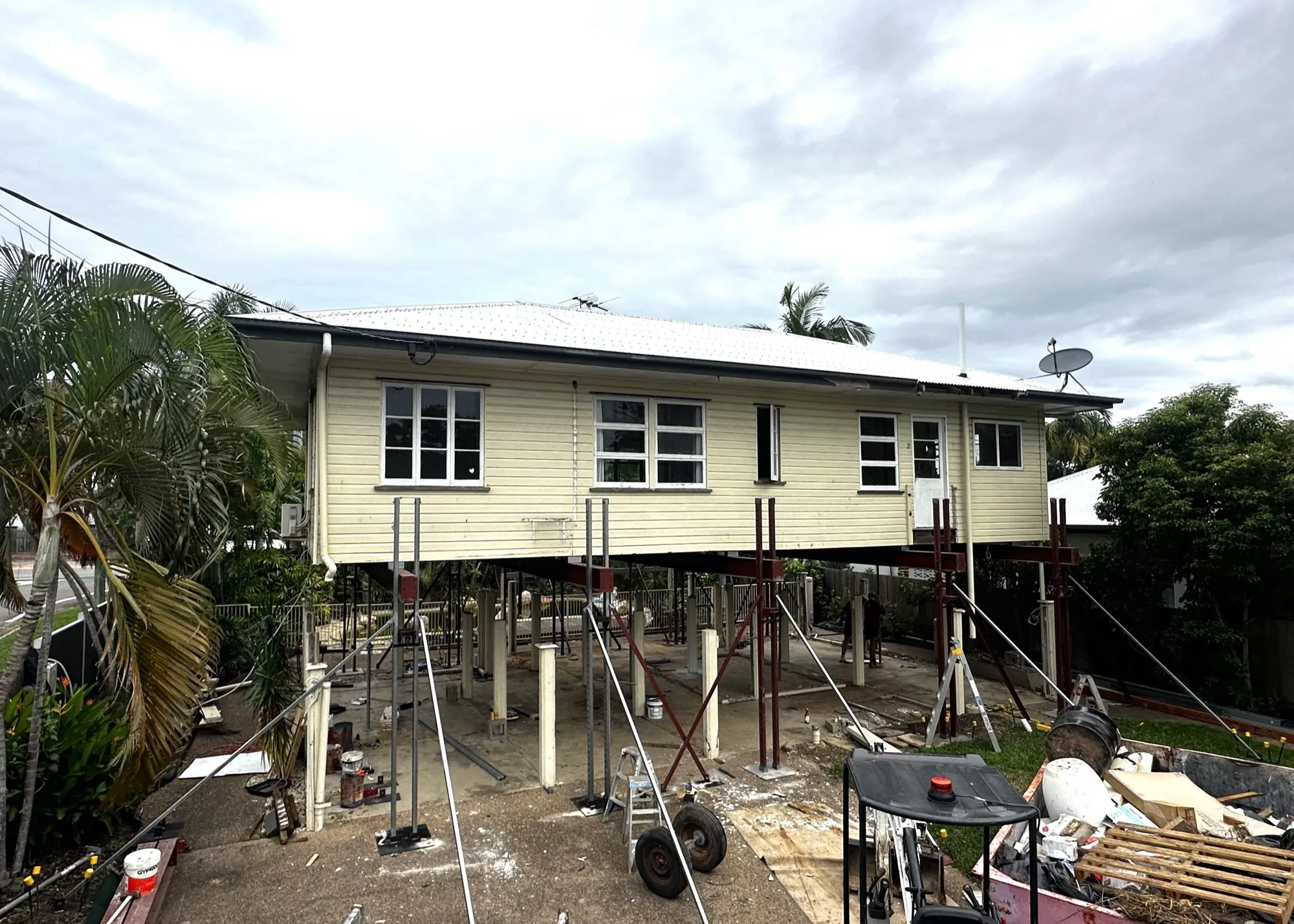 A Queenslander standing on steel props, part way through a house lift